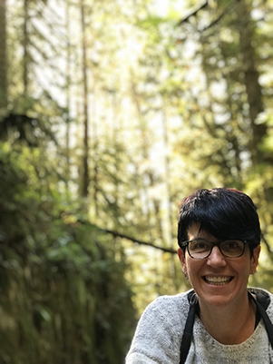 Helga backed by trees in sun